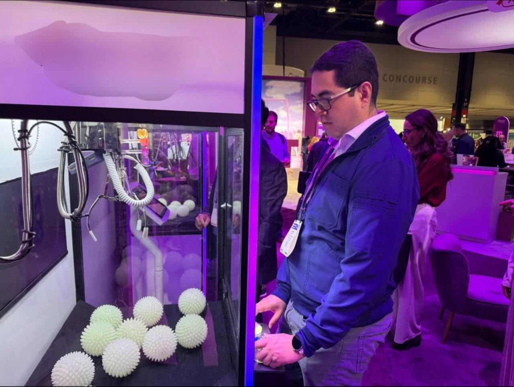 person playing claw machine game at event