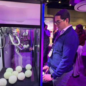 person playing claw machine game at event