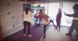 people are kicking virtual object as screen show