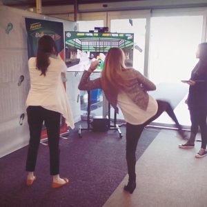 people are kicking virtual object as screen show